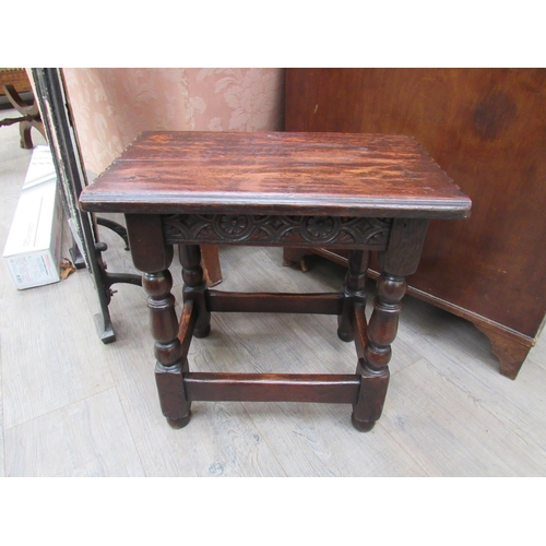 7822 - A 19th Century revival oak joint stool, the chip carved seat over a carved frieze on turned square l... 