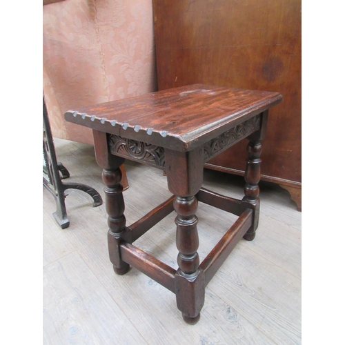 7822 - A 19th Century revival oak joint stool, the chip carved seat over a carved frieze on turned square l... 