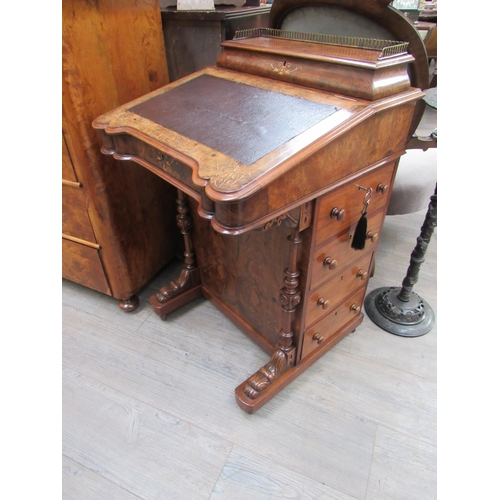 7826 - Circa 1860.  An inlaid burr walnut Davenport with birds eye maple interior, the pierced brass galler... 