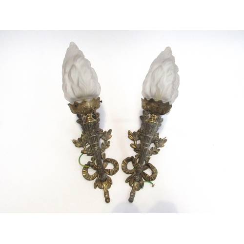 7827 - A pair of ormolu wall brackets in classical torch style, with frosted glass flame shades