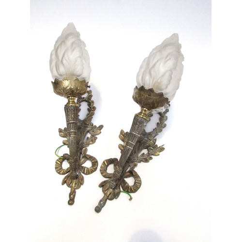 7827 - A pair of ormolu wall brackets in classical torch style, with frosted glass flame shades