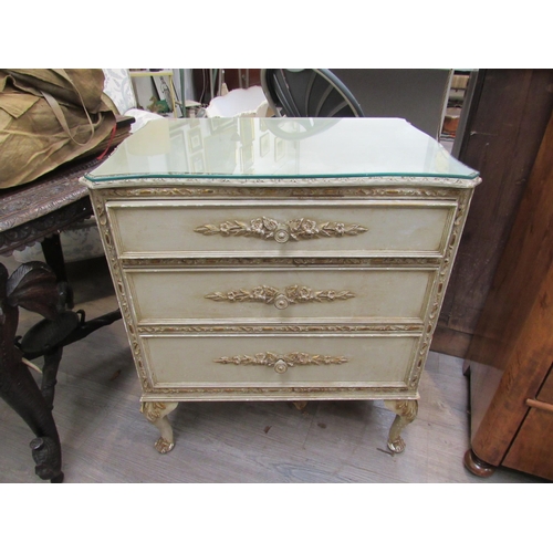 7831 - An 18th Century style painted and gilt chest of small proportions, the three drawers on carved cabri... 