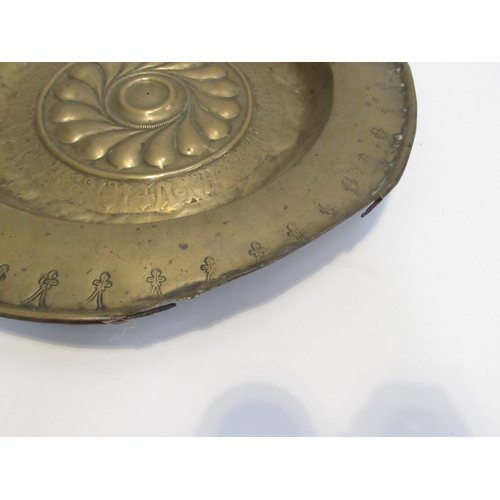 7832 - A 17th Century brass alms dish, some damage present, 39.5cm diameter