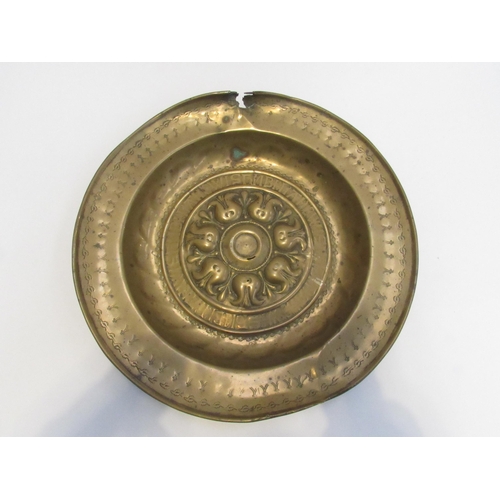 7833 - A 17th Century brass alms dish, some damage present, 41cm diameter