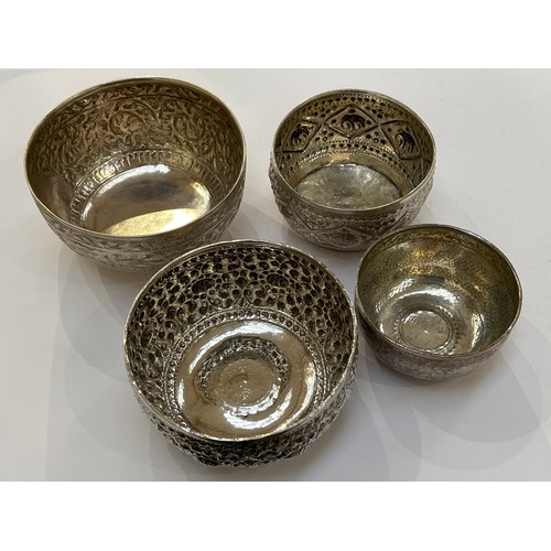 7317 - Four Indian silver engraved and embossed bowls varying sizes decorated with flowers and elephants, 5... 