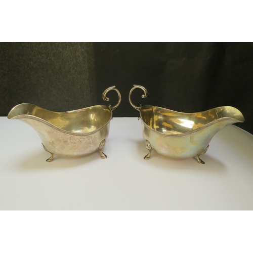 7374 - A pair of E.S Barnsley & Co. silver sauce boats, Birmingham 1911, monogrammed 