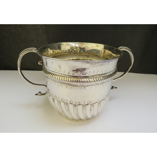 7385 - A silver Queen Anne porringer, London 1713, possibly Nathaniel Locke, 16.5cm diameter to handles, 9.... 