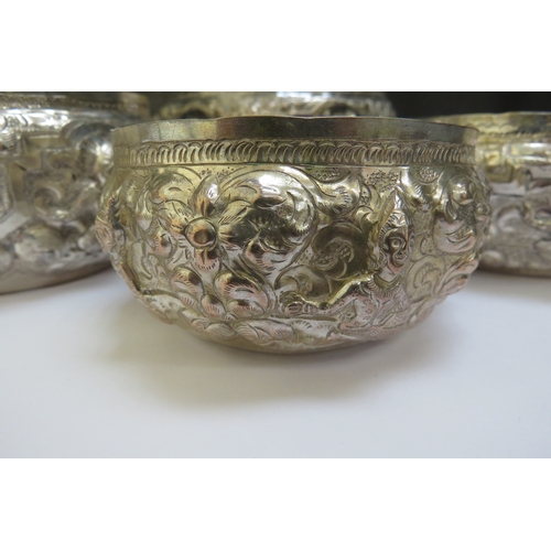 7388 - Four Indian silver embossed bowls of graduated size decorated with figures, waves, vine, marks to ba... 