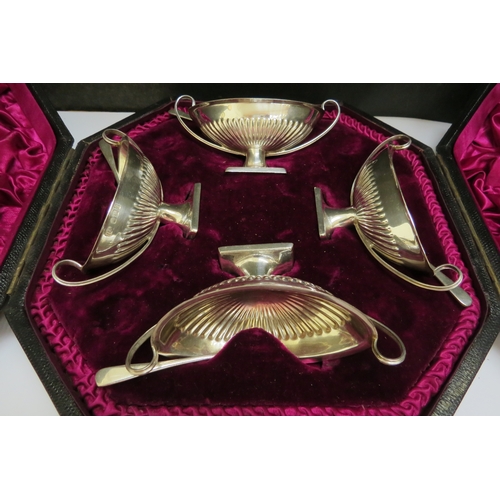 7396 - An Atkin Brothers silver four piece salt set of boat form, Sheffield 1895 with a set of four Francis... 