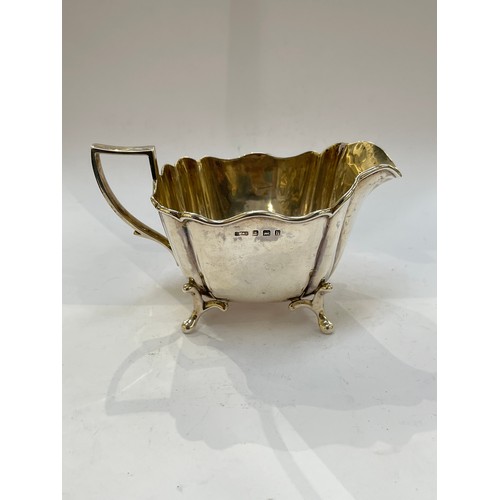 7334 - A Charles Westwood and Sons silver jug, raised on four feet, Birmingham 1907, 157g