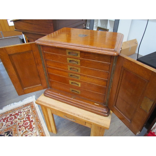 7508 - An early 20th Century honey oak collector’s chest / cutlery canteen, the twin panelled doors opening... 