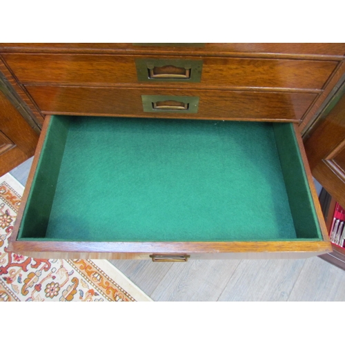 7508 - An early 20th Century honey oak collector’s chest / cutlery canteen, the twin panelled doors opening... 