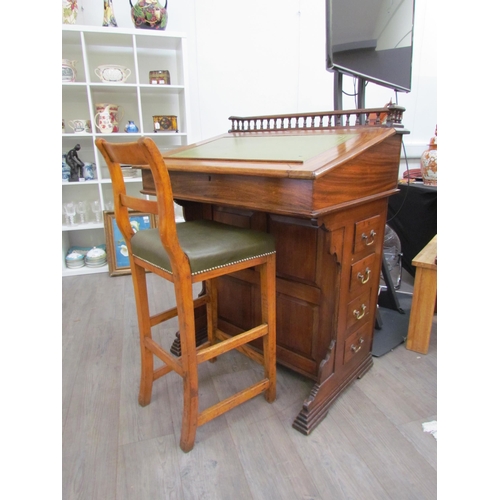 7510 - A circa 1900 shipping clerk’s desk, spindle gallery back, green tooled leather sloped surface with l... 