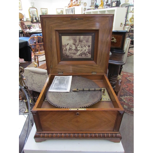 7648 - A 19th Century walnut cased table Polyphon, marquetry inlaid top, with approximately 25 15.5'' discs... 