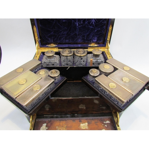 7649 - A 19th Century coromandel travelling vanity box fitted with silver lidded cut crystal glass containe... 