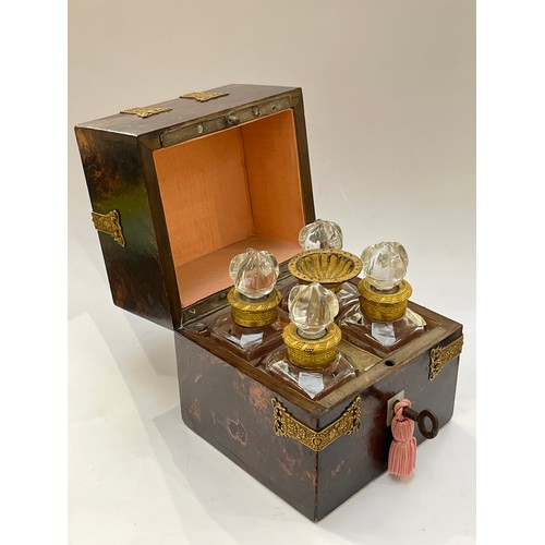 7348 - A 19th Century French scent bottle set, the case with figured hardwood veneer, with applied gilt bra... 