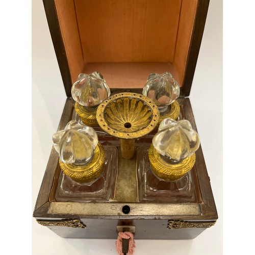 7348 - A 19th Century French scent bottle set, the case with figured hardwood veneer, with applied gilt bra... 