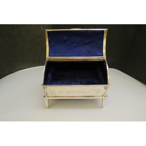 7361 - A William Comyns & Sons silver casket, domed top with twin hinged lids, swag detail, raised on feet,... 