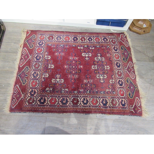 7743 - An Afghan rug, burgundy ground with geometric patterns, 115cm x 92cm