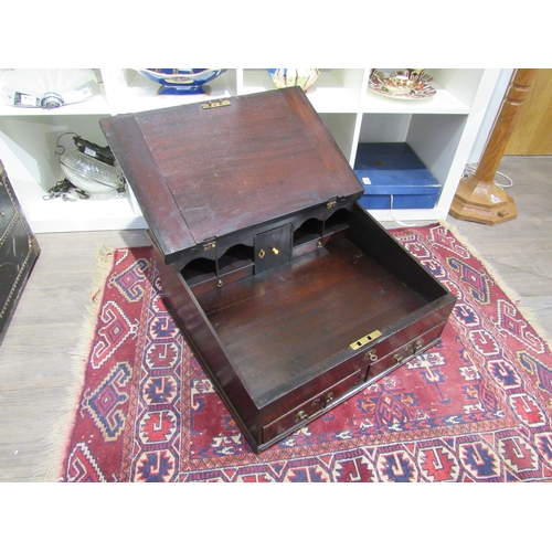 7744 - A George III mahogany table top desk, the hinged slope with key and fitted interior over two base dr... 