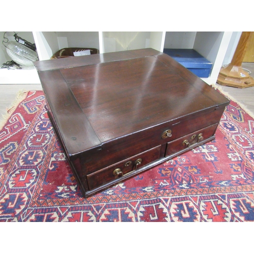 7744 - A George III mahogany table top desk, the hinged slope with key and fitted interior over two base dr... 