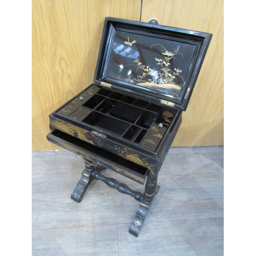 7752A - A 19th Century chinoiserie lacquer sewing table decorated with birds, foliage on turned column legs