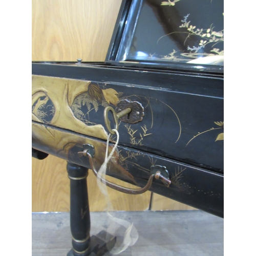 7752A - A 19th Century chinoiserie lacquer sewing table decorated with birds, foliage on turned column legs