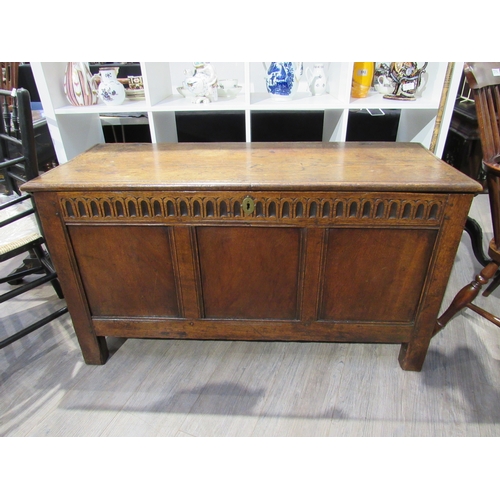 7753 - A 17th Century oak three panel coffer with ring split hinges and carved decoration over stile feet, ... 