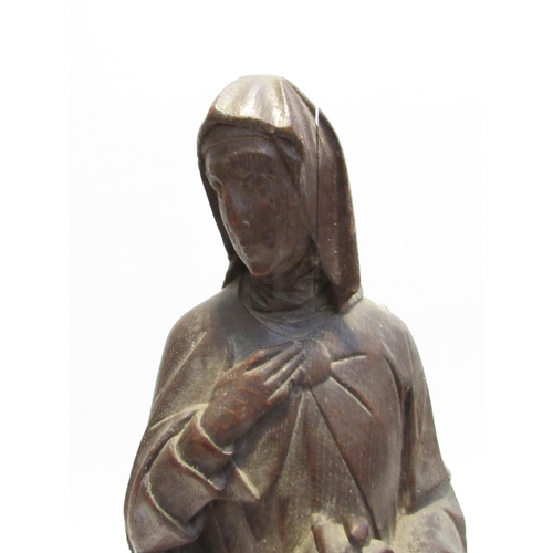 7792 - A 19th Century carved oak figure of a nun, standing 56cm high