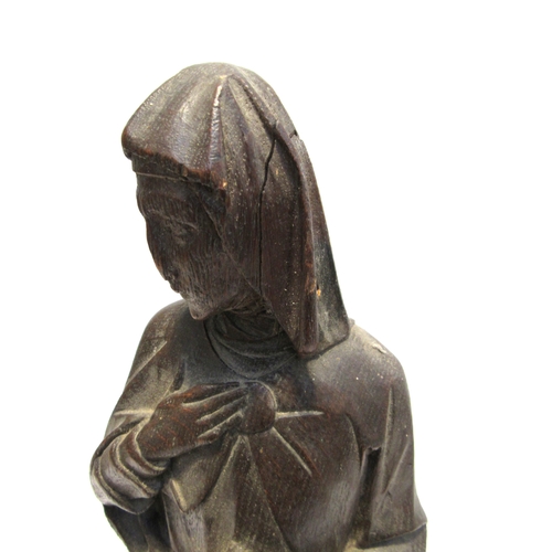 7792 - A 19th Century carved oak figure of a nun, standing 56cm high