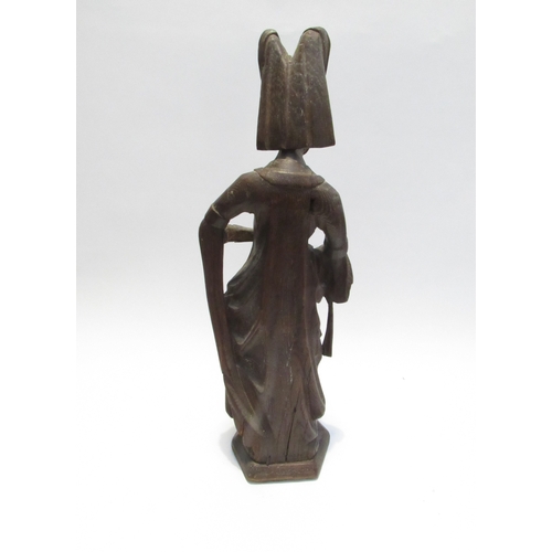 7792A - A 19th Century oak carved sculpture of a Pleurant / weeper, 61cm high