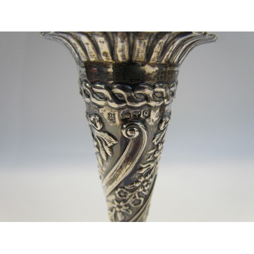 7428 - A near pair of silver embossed bud vases, 11g total