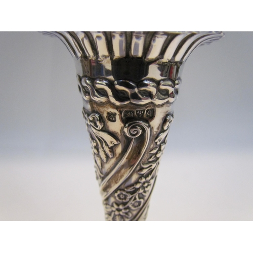 7428 - A near pair of silver embossed bud vases, 11g total