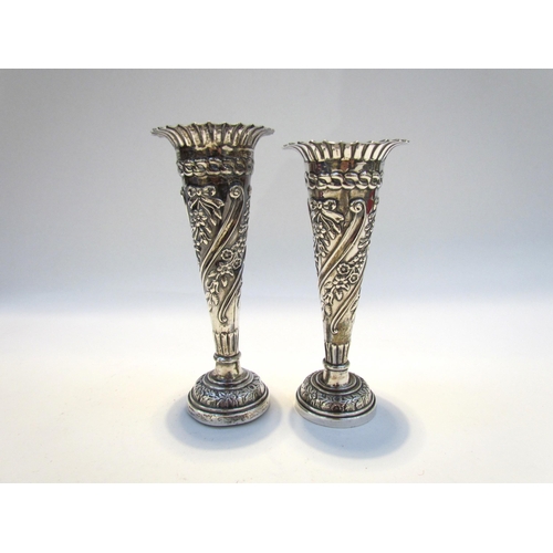 7428 - A near pair of silver embossed bud vases, 11g total