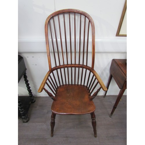 7591 - A pair of circa 1800 his and hers Windsor chairs, the hoop and stick-back over a solid elm seat, on ... 