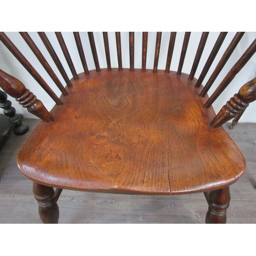 7591 - A pair of circa 1800 his and hers Windsor chairs, the hoop and stick-back over a solid elm seat, on ... 