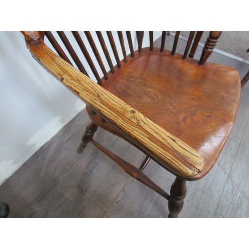 7591 - A pair of circa 1800 his and hers Windsor chairs, the hoop and stick-back over a solid elm seat, on ... 