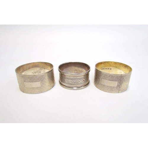 7216 - A cased pair of R.N. Holling & Co, silver napkin rings, Birmingham 1944 and another silver example (... 