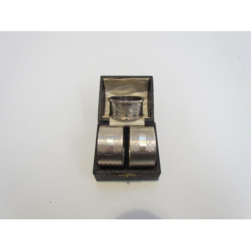 7216 - A cased pair of R.N. Holling & Co, silver napkin rings, Birmingham 1944 and another silver example (... 