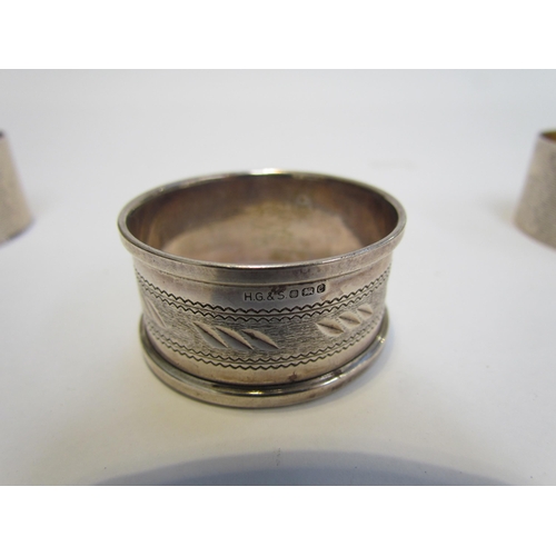 7216 - A cased pair of R.N. Holling & Co, silver napkin rings, Birmingham 1944 and another silver example (... 