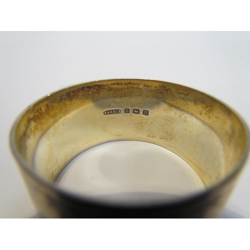 7216 - A cased pair of R.N. Holling & Co, silver napkin rings, Birmingham 1944 and another silver example (... 