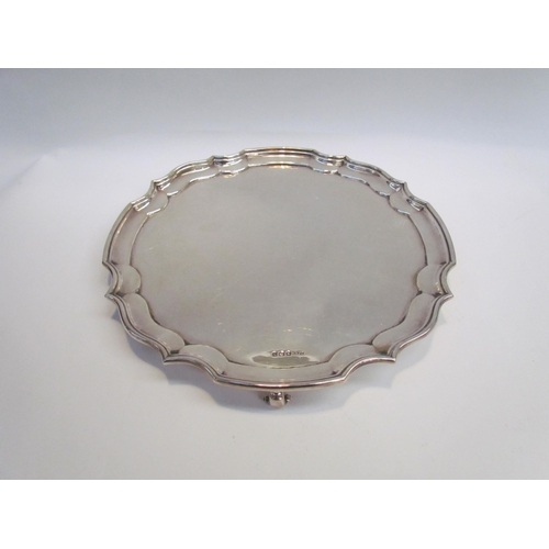 7403 - A Harrison Fisher & Sons silver salver with pie-crust edge raised on 3 feet. Sheffield 1946, 30cm di... 