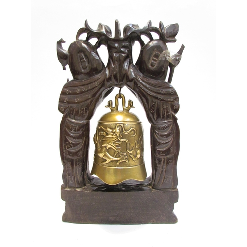 7602 - An Oriental carved hardwood and brass bell, 45cm high