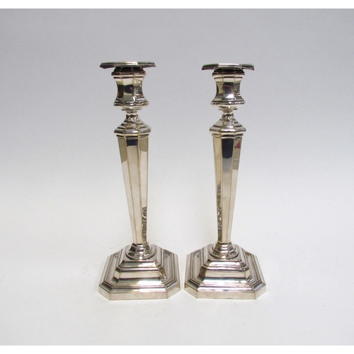 7602A - A pair of silver plated candlesticks, canted square bases, 25.5cm high