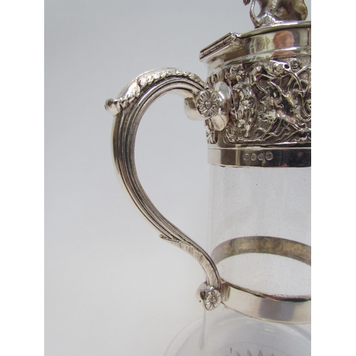 7609A - A Hukin & Heath silver plated glass carafe with border of cherubs and putti playing, lion and shield... 