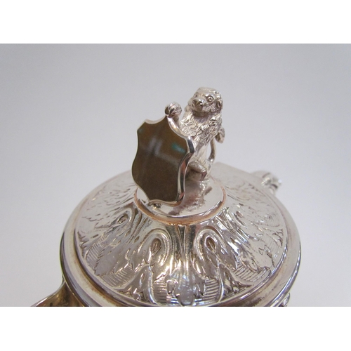 7609A - A Hukin & Heath silver plated glass carafe with border of cherubs and putti playing, lion and shield... 