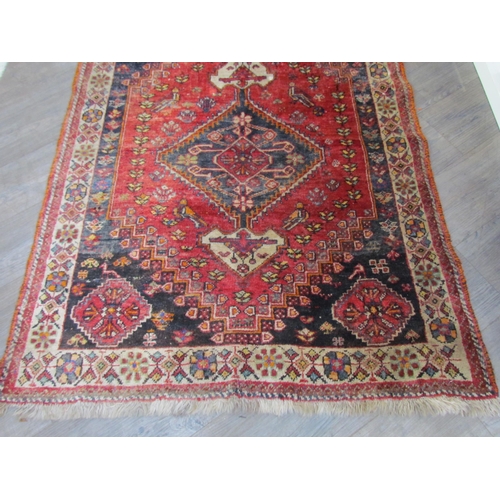 7610 - A Persian hand knotted wool rug, red ground with birds and floral borders, 155cm x 115cm