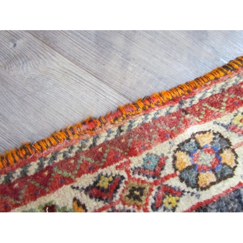 7610 - A Persian hand knotted wool rug, red ground with birds and floral borders, 155cm x 115cm