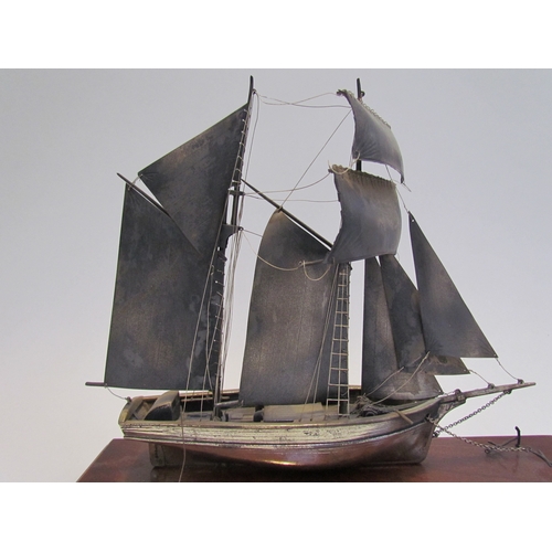 7620 - A silver model of a sailing vessel, hallmark indistinct, 22cm tall, on plinth base