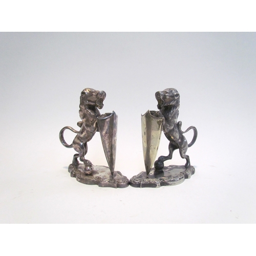 7631 - A pair of Walker & Hall silver plated lions with shields, stamped 17044 to base, each 12.5cm tall